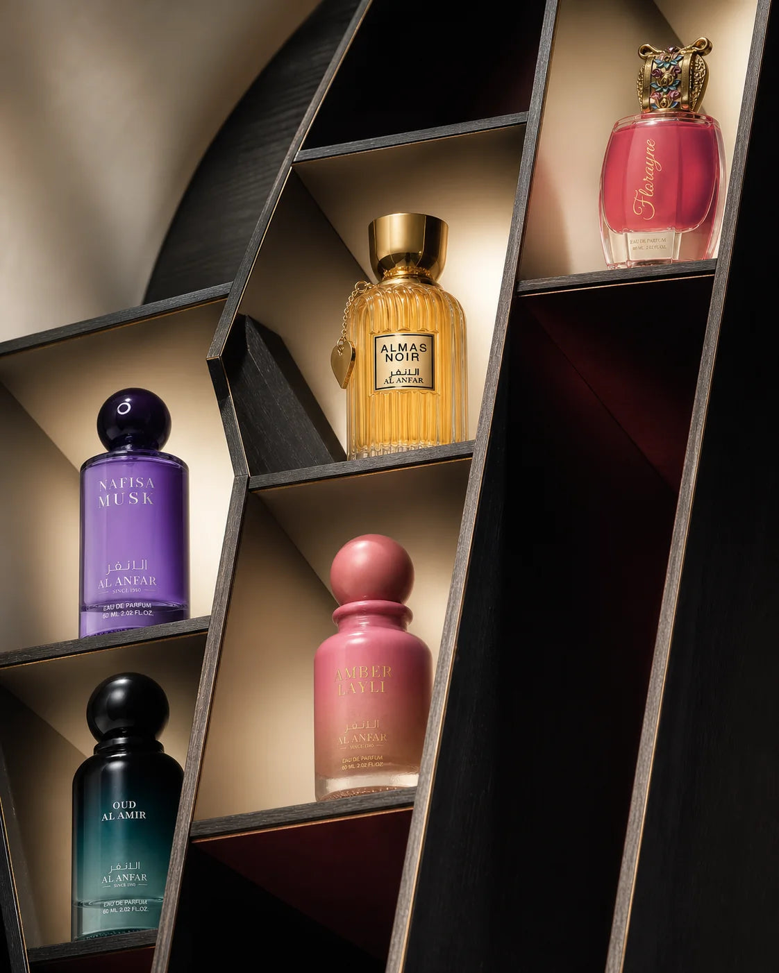 Five Al Anfar fragrances displayed within an architectural fragrance cabinet
